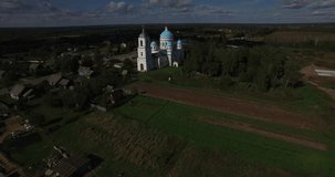 Aerial drone video of old church in Yaroslavl Oblast area in the afternoon, Novoye selo village, located near ancient town of Pereslavl 150 km north-east of Moscow, the capital of Russia