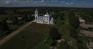 Aerial drone video of old church in Yaroslavl Oblast area in the afternoon, Rahmanovo selo village, located near ancient town of Pereslavl 150 km north-east of Moscow, the capital of Russia