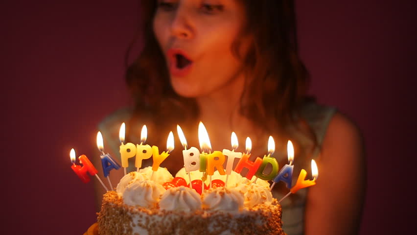 young woman blowing out candles on Stock Footage Video (100% Royalty ...