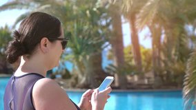 High quality video of woman checking her e-mails on cellphone on the vacations in 4k
