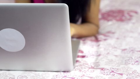 Tilt up shot of a woman using a laptop