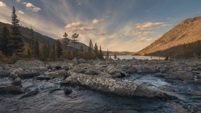 Mountains and river with a rapids flowing in a valley between mountain on a sunny autumn day timelapse, Siberia