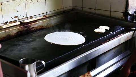 Locked-on shot of chefs preparing dosa, Chennai, Tamil Nadu, India