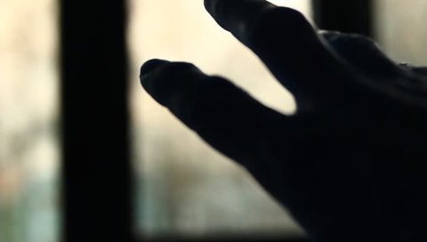 Male hand grabbing for the light in a dark room. Close up of male palm hand. Artistic clip.
Loneliness. Unhappy. Seeking for something new.