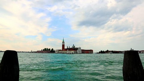 Time lapse shot of a basilica at canal side, St Marks Campanile, St Marks Basilica, Grand Canal, Venice, Veneto, Italy