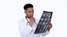 Serious man doctor looking at x-ray image attentively isolated