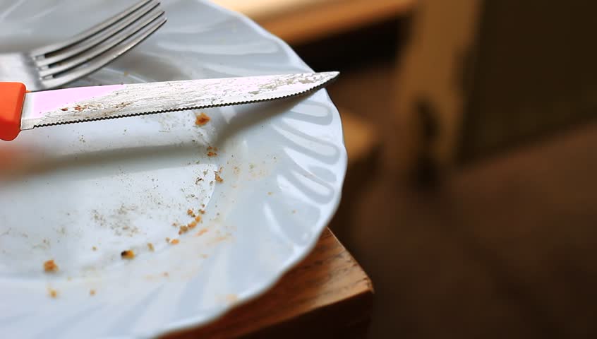 Empty plate after eating food. With fork and knife on it. Royalty-Free Stock Footage #26489216