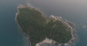 Aerial video of sea and heart shaped small island off the coast of Thailand during sunset