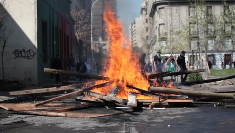 Street Fire. Street damage caused during a student strike on September 22, 2011 in Santiago, Chile. Protesters demand the government to improve education quality.