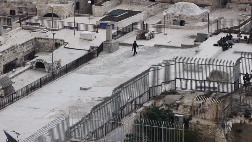 Judean man is walking on the roofs of Jewish quarter on November 08, 2011, Jerusalem, Israel. Old city roofs is a must see sight in Jerusalem.