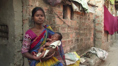 Young Indian mother holding sleeping child