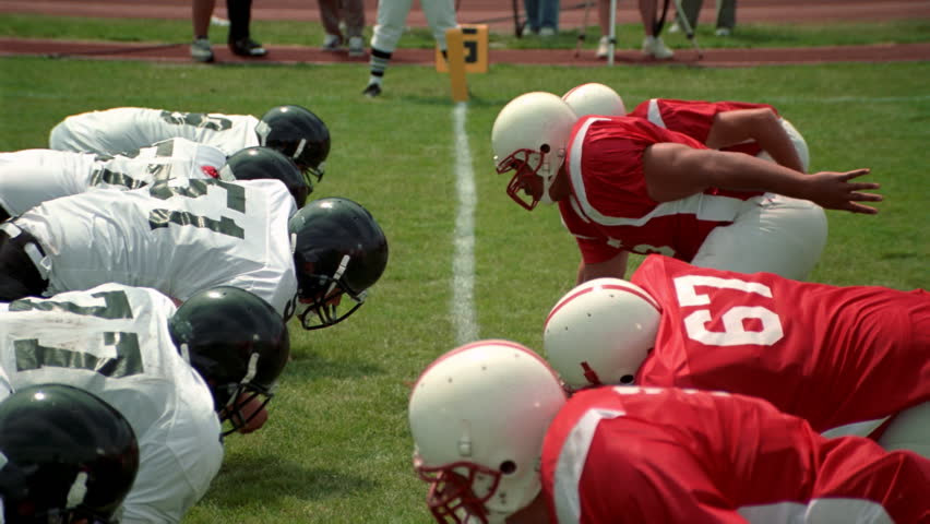 Opposing football players crashing into each other and falling down | Shutterstock HD Video #26501222