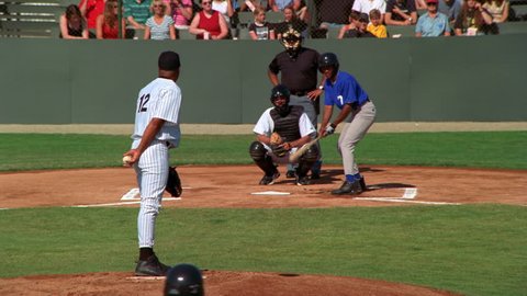 Pitcher pitching a walk at a ball game