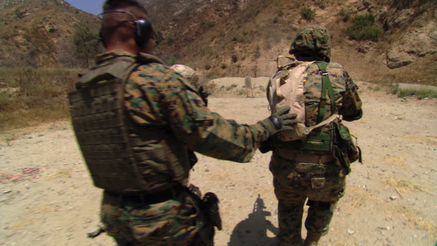 Marine training officer and trainees moving in on a firing-range target