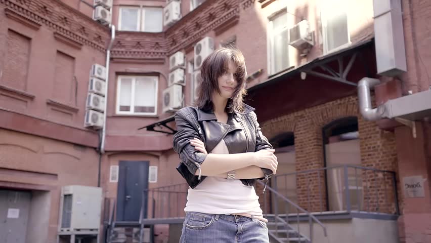 Circular flight of the camera from the girl walking in the courtyards of the city