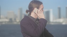 Profile shot of a young business man talking on his phone - Powered by Shutterstock - Get 15% off with code: PIKWIZARD15