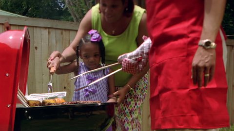 Family using barbecue grill