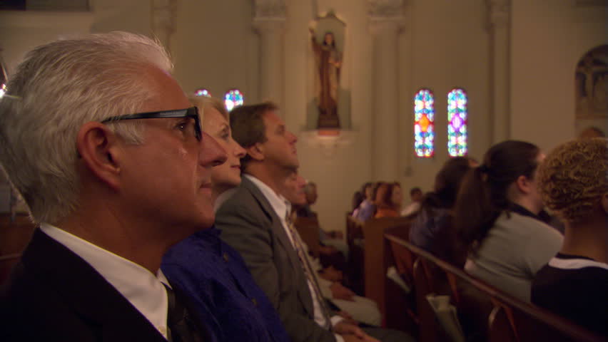 Side view of congregation kneeling in pews and bowing heads | Shutterstock HD Video #26509001