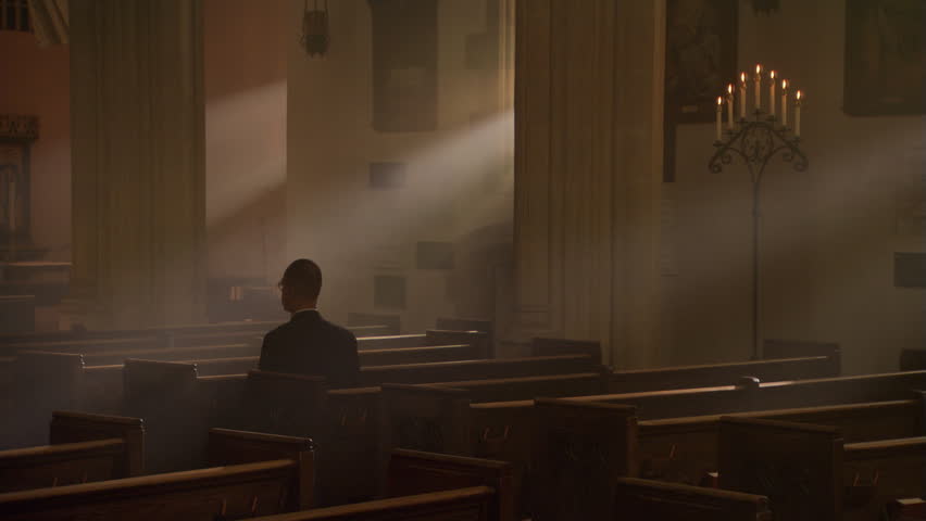 Man kneeling and praying in nave of Catholic church | Shutterstock HD Video #26509187