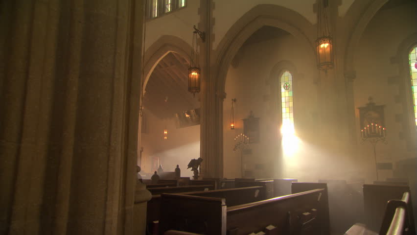 Sunbeams through stained glass windows in Catholic church, nun walking up aisle | Shutterstock HD Video #26509196
