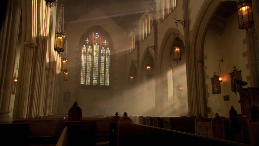 Nun kneeling among sun rays streaming through stained glass windows | Shutterstock HD Video #26509271