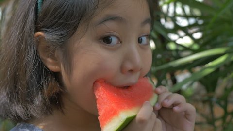 4K : Close up of Asian child girl eating delicious water melon