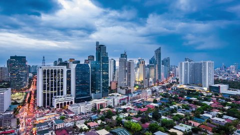 Manila, Philippines - April 17, 2017: Dramatic sky over Makati City in Metro Manila, Philippines, day to night time lapse view.