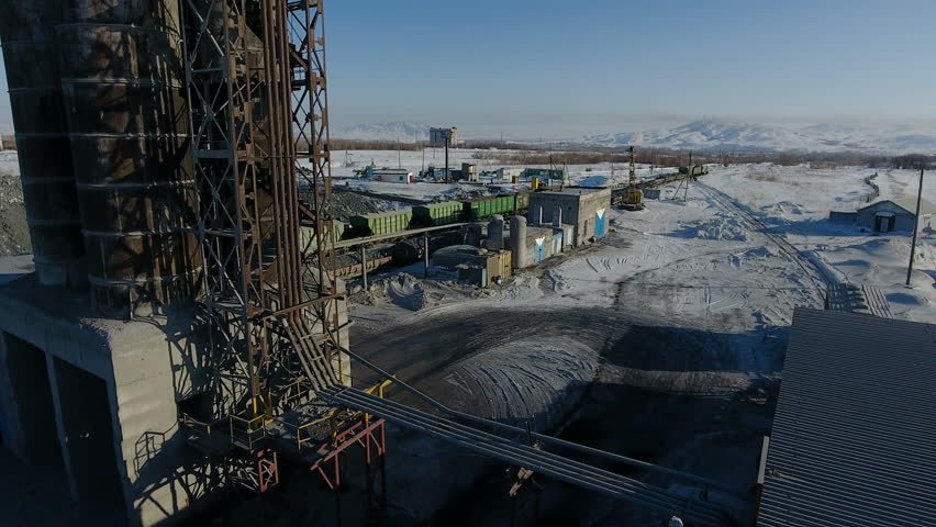 Aerial view of ore storage producing copper in winter. Large industrial area from above.