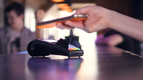 Person using Credit Card Terminal for wireless payment with smartphone. 4K.