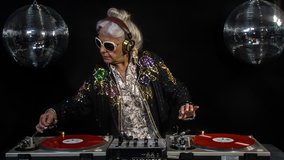 amazing DJ grandma, older woman djing and partying in a disco setting. these retired rockers will get the party going