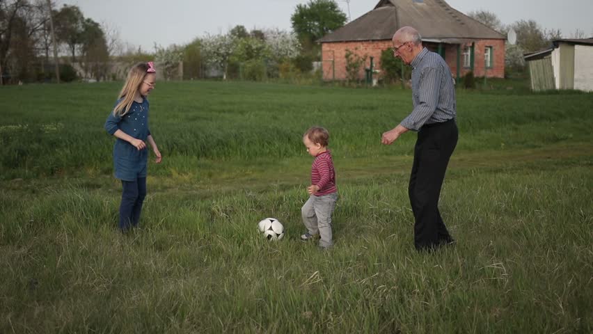Multi generation family playing soccer together Royalty-Free Stock Footage #26525669