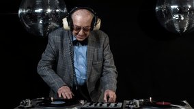 amazing DJ grandpa, older man djing and partying in a disco setting. these retired rockers will get the party going