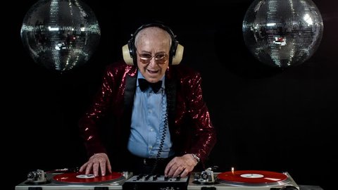 amazing DJ grandpa, older man djing and partying in a disco setting. these retired rockers will get the party going