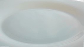 White rice pours selected on a plate that rotates. Video food 360.