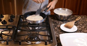 Flipping pancake over in hot frying pan 