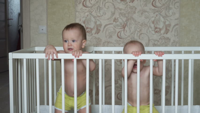 Two cute little brothers jump in one cot Royalty-Free Stock Footage #26540546
