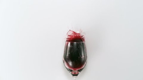 Red wine splashing out of glass shooting with high speed camera, phantom flex.
