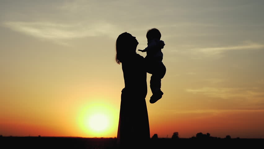 Happy child rushes into hands of mother. Family hugs over sunset sky background. Silhouettes of anonymous boy and woman outside in summer or autumn landscape. Slow motion 180fps Royalty-Free Stock Footage #26542796