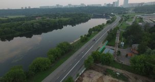 Aerial drone video with view of Krylatskoye area of Moscow, sports fields and buildings, river Moscow, Grebnoy Channel, old orthodox church and surroundings in western side of the capital of Russia