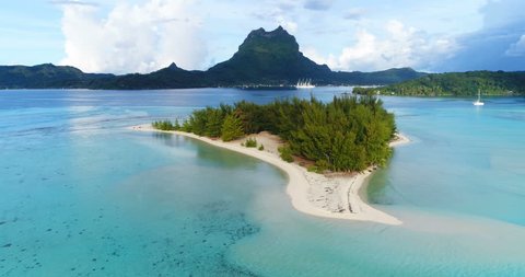 Bora Bora in French Polynesia. Aerial view of Motu paradise island and turquoise blue water in coral reef lagoon and Mt Pahia, Mount Otemanu, Tahiti, South Pacific Ocean.