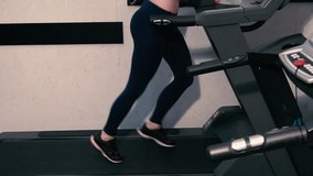 Young Girl Training On Treadmill In The Gym. Slow motion