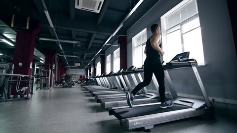 SLO MO LA Medium Shot Pan Man jogging on treadmill