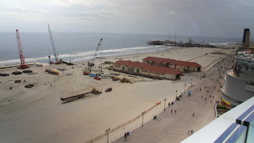 This is a time lapse shot of construction work being done on the beach at Atlantic City from a high vantage point.