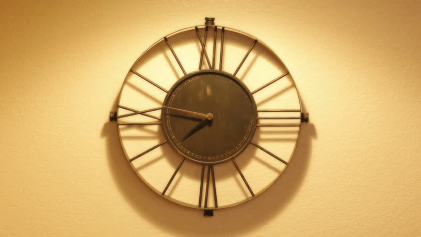 A slow push into a time lapse shot of a wall clock