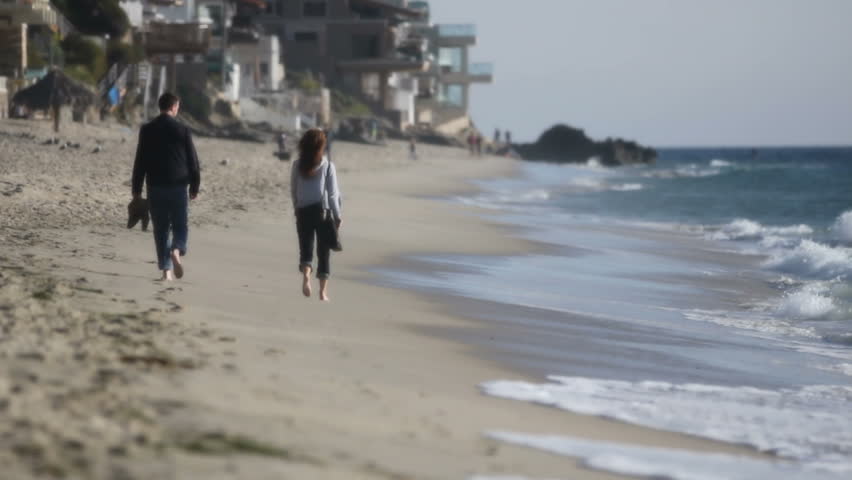 People walk on beach 