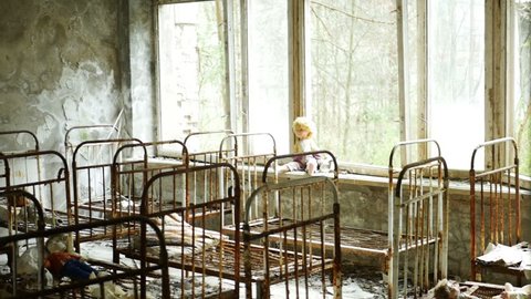 Children's beds in kindergarten of a ruined house in the abandoned city of Pripyat after the tragedy at the Chernobyl nuclear power plant. Conceptual video about child missing or kidnapping