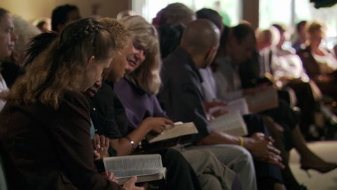 Seated congregation reading their Bibles