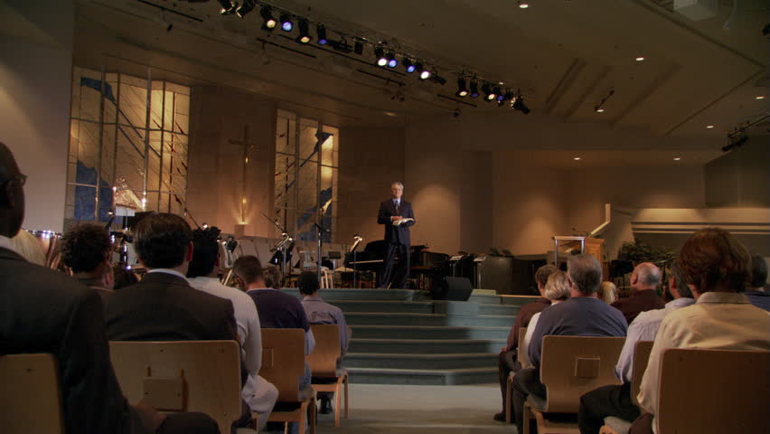 Pastor closing sermon, congregation rising, zoom-in to praying pastor | Shutterstock HD Video #26581241