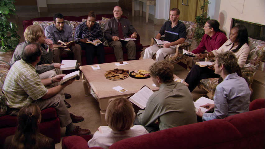 Adult Bible study group seated around low table | Shutterstock HD Video #26581628