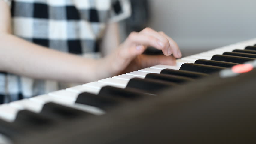 Little girl learning to play the piano. Royalty-Free Stock Footage #26586620